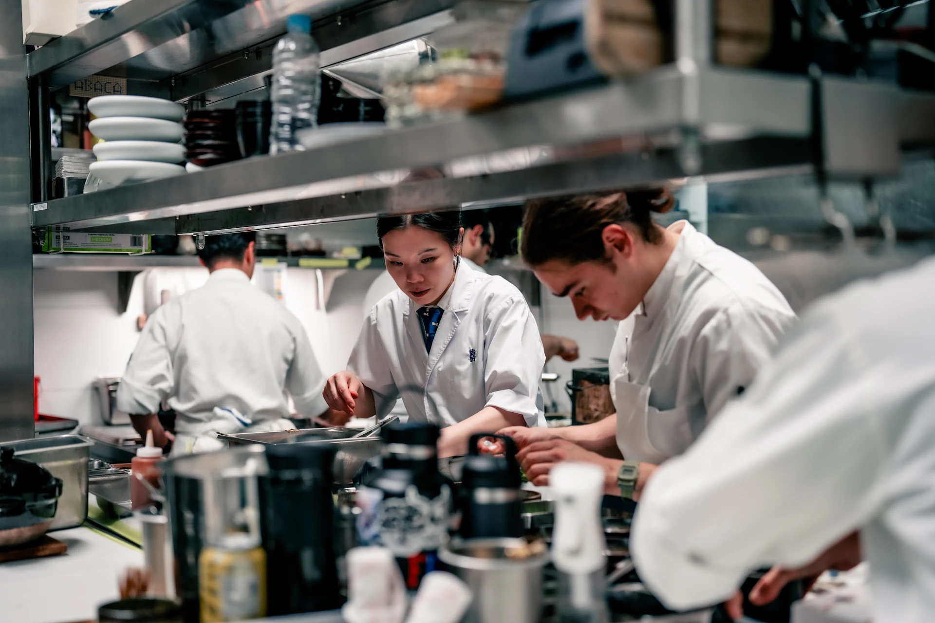 A group of chefs in a kitchen preparing food