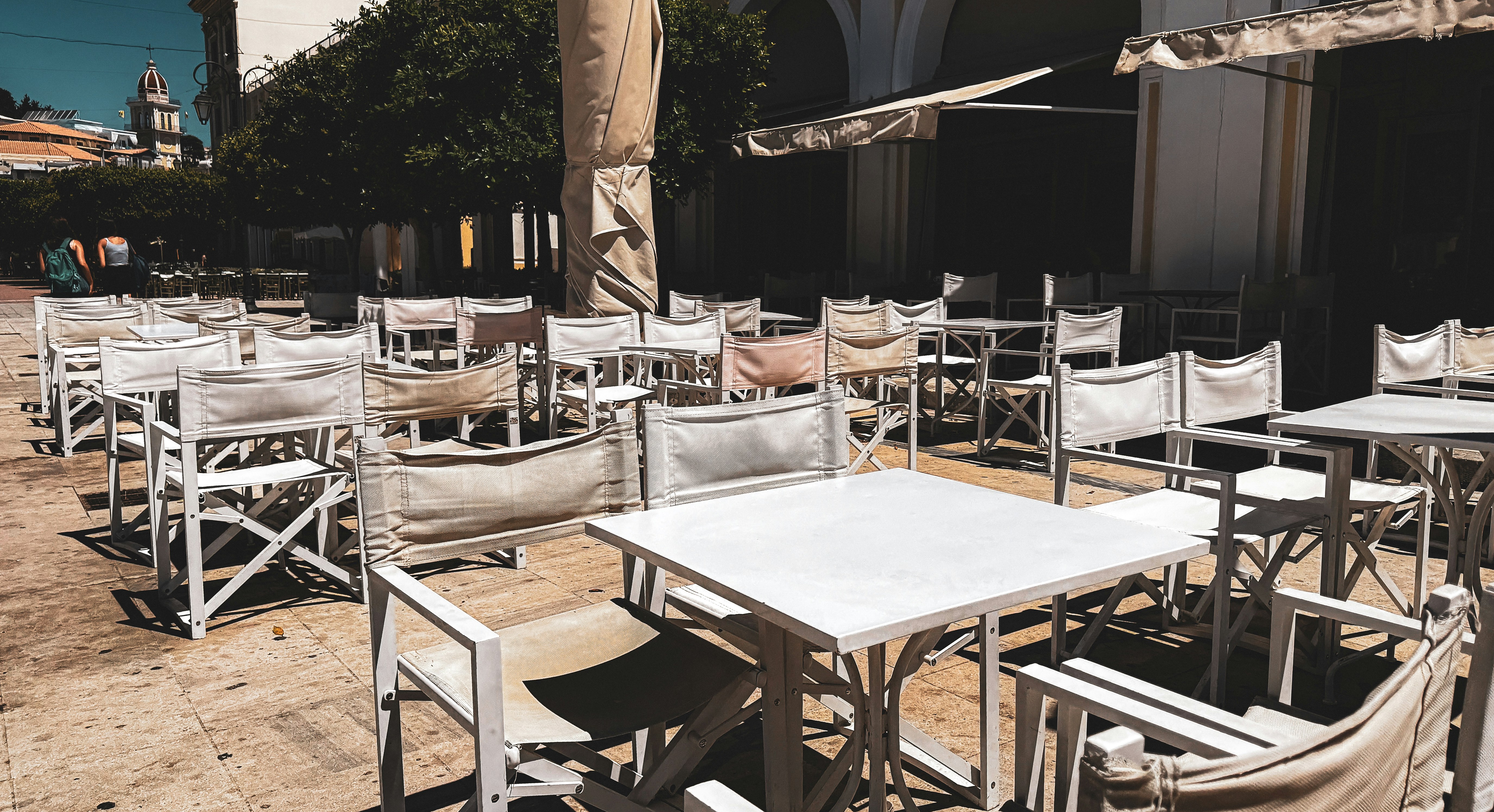 A bunch of tables and chairs that are outside
