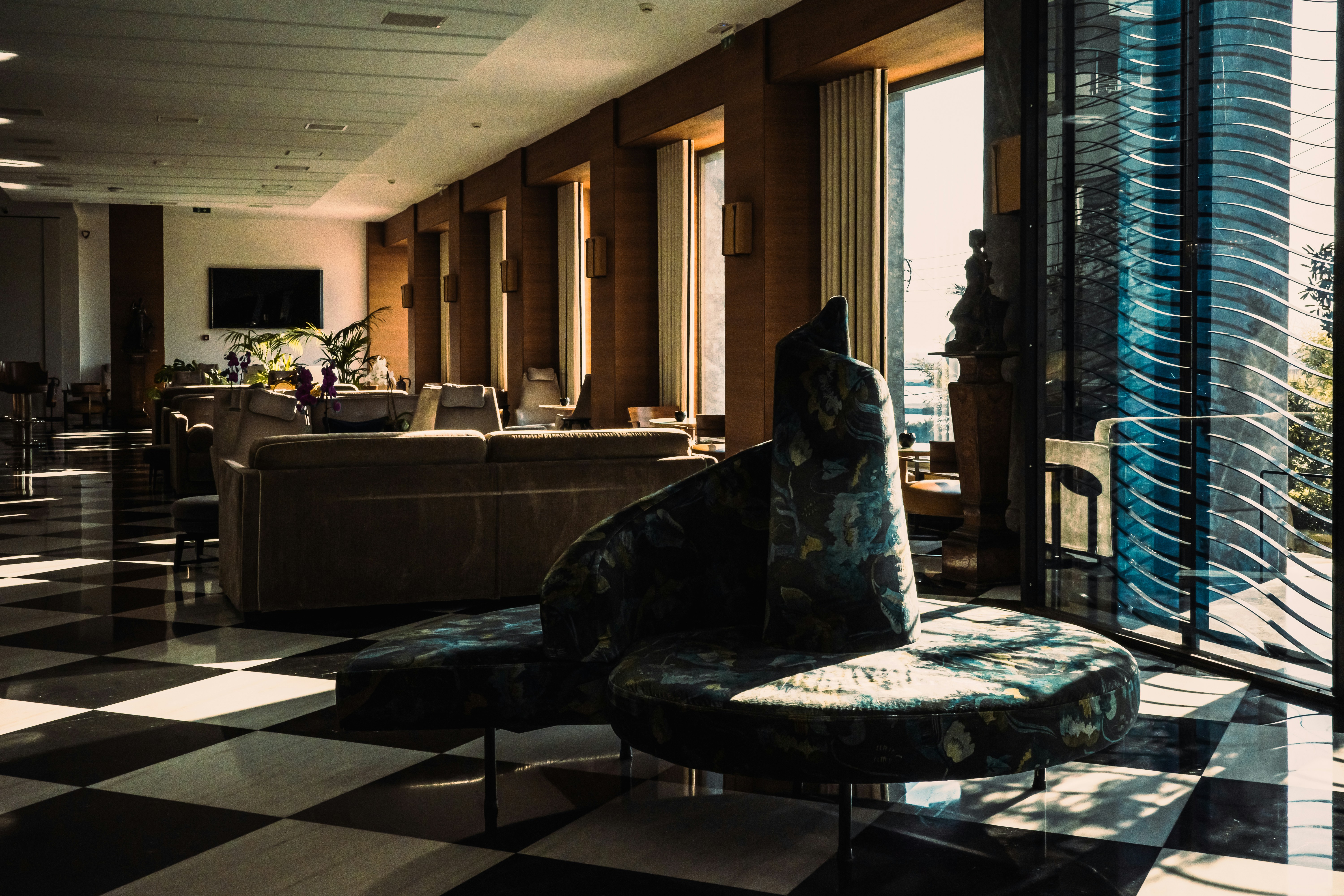 A living room filled with furniture and a checkered floor