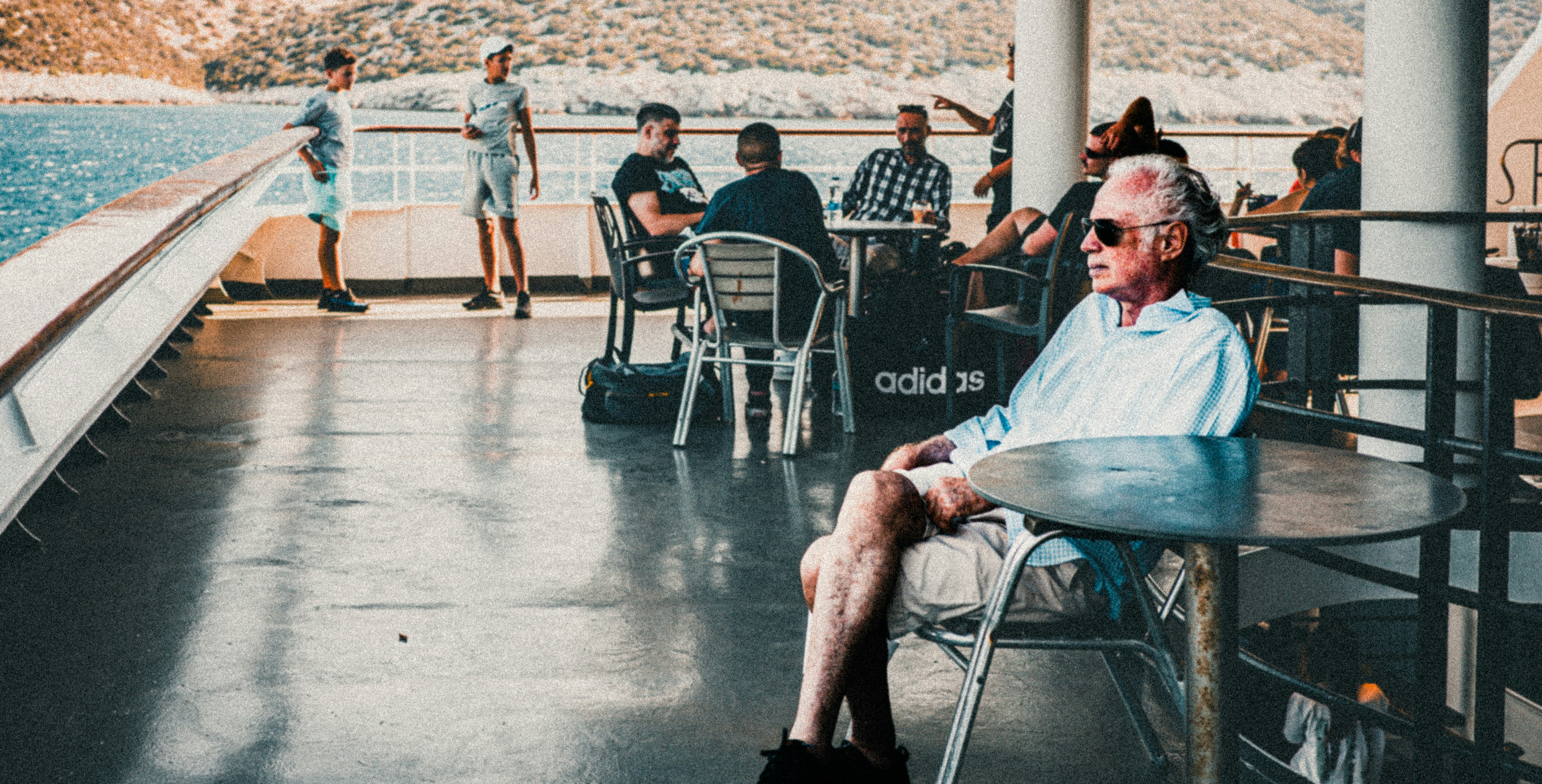 A group of people sitting at tables on a boat