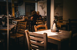 A person sitting at a table in a restaurant