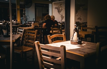 A person sitting at a table in a restaurant