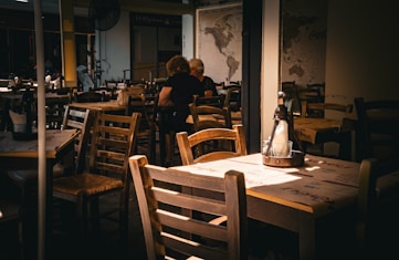 A person sitting at a table in a restaurant