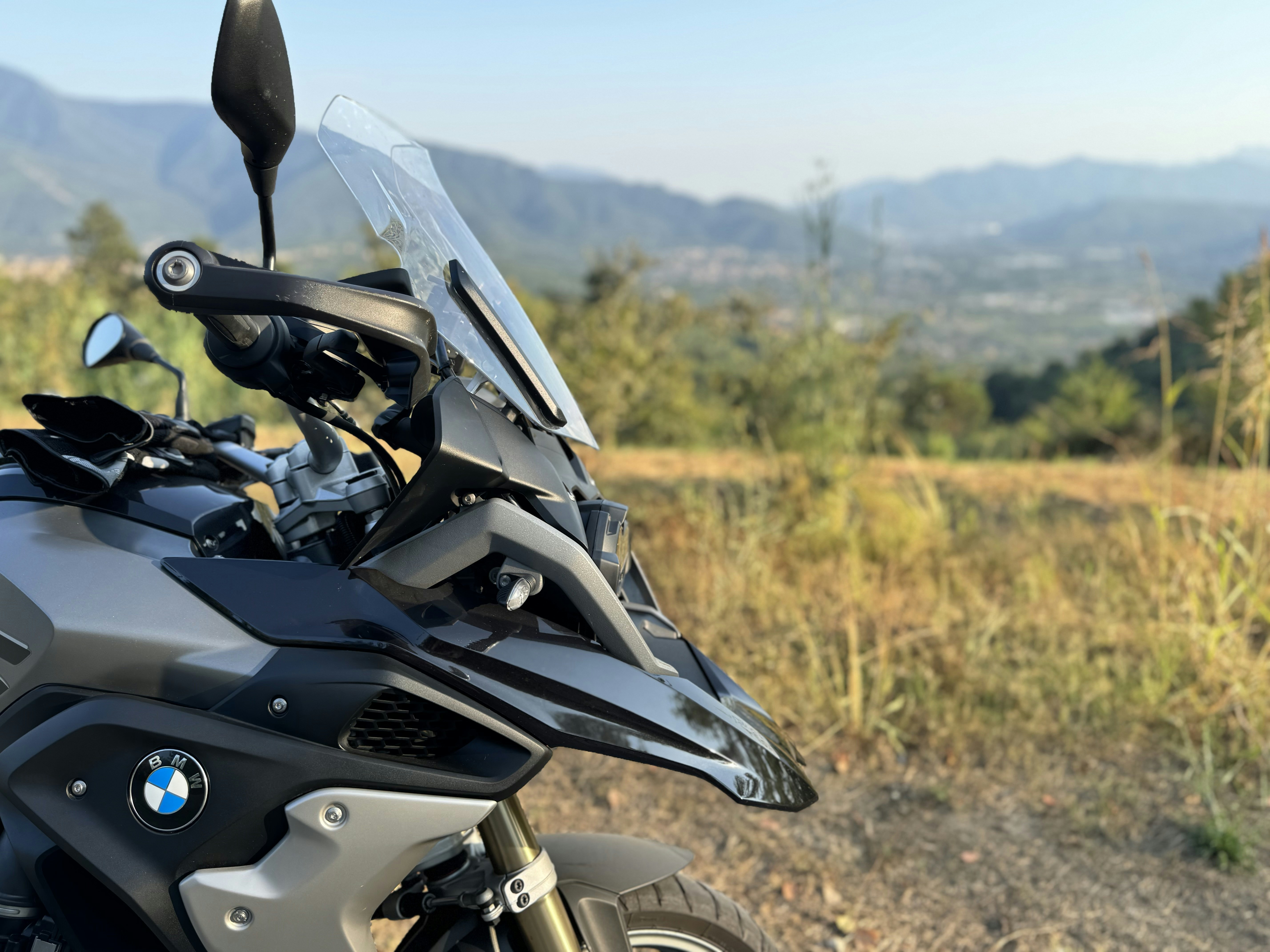 A motorcycle parked on the side of a dirt road