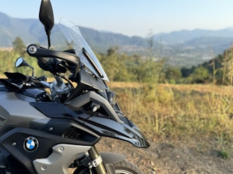 A motorcycle parked on the side of a dirt road
