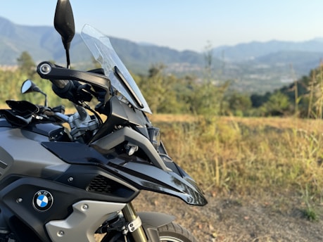 A motorcycle parked on the side of a dirt road