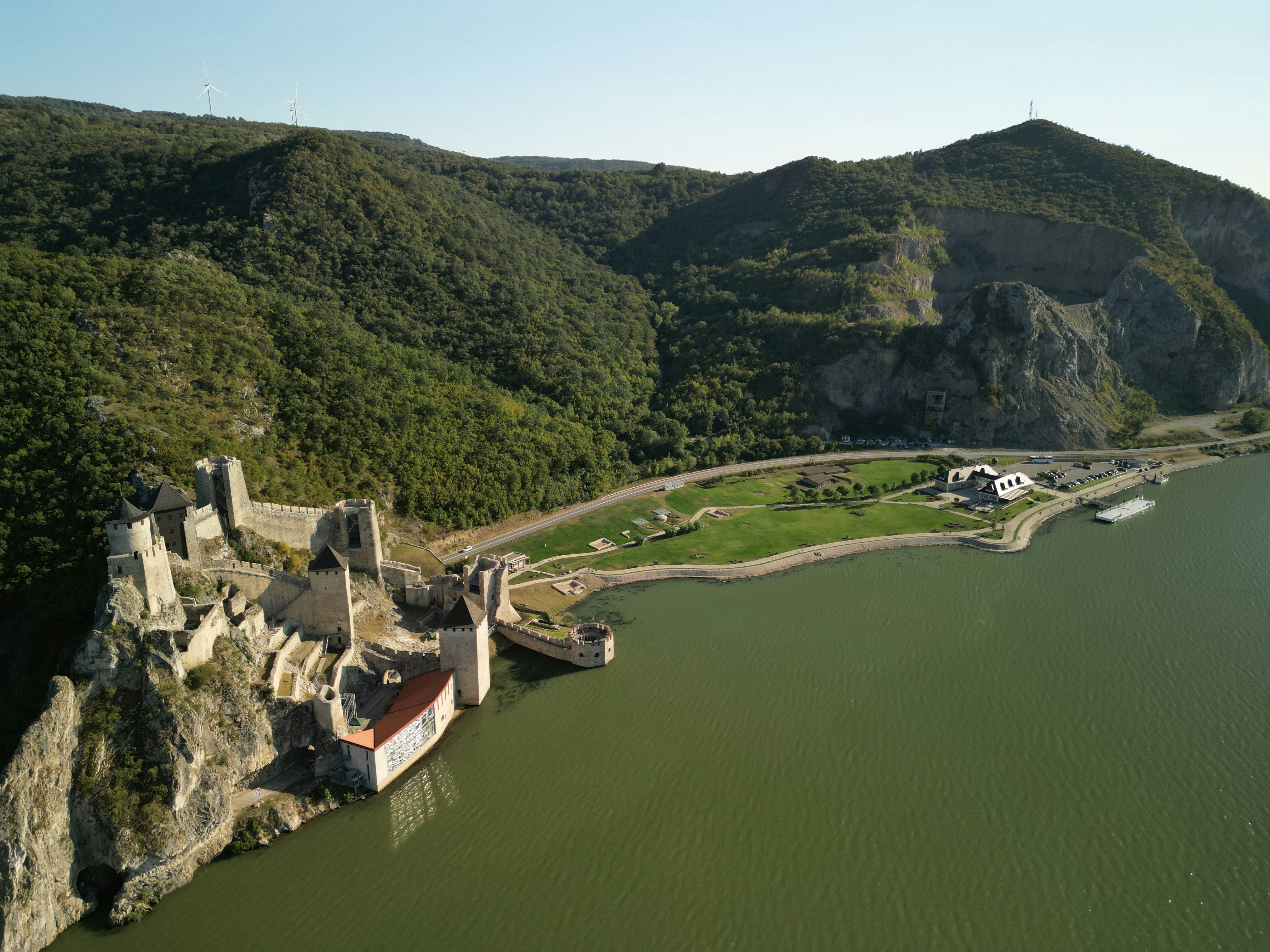 An aerial view of a castle on a cliff overlooking a body of water