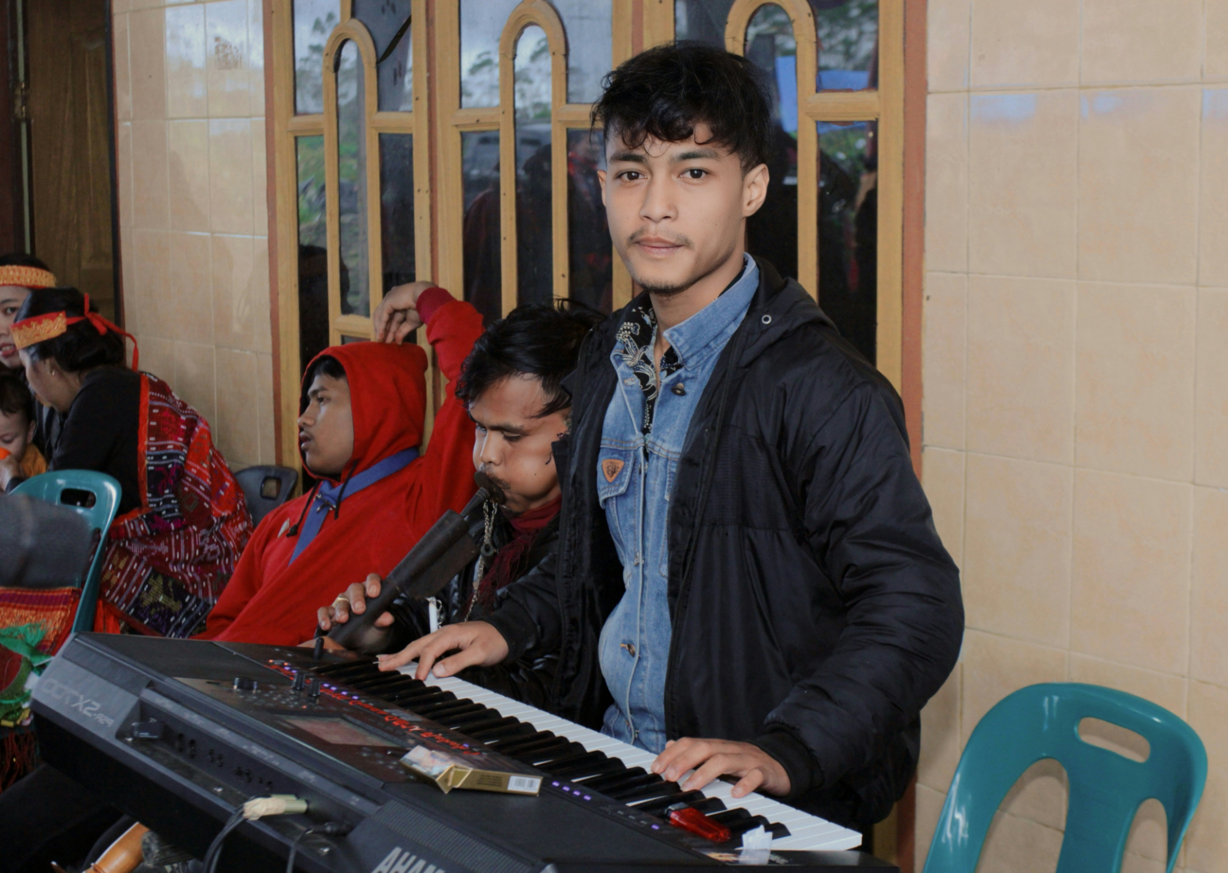 Man playing keyboard in front of group