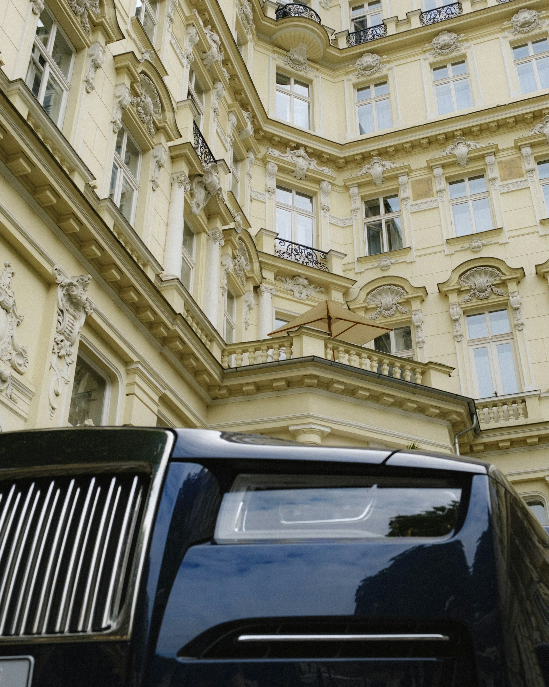 A black truck parked in front of a tall building