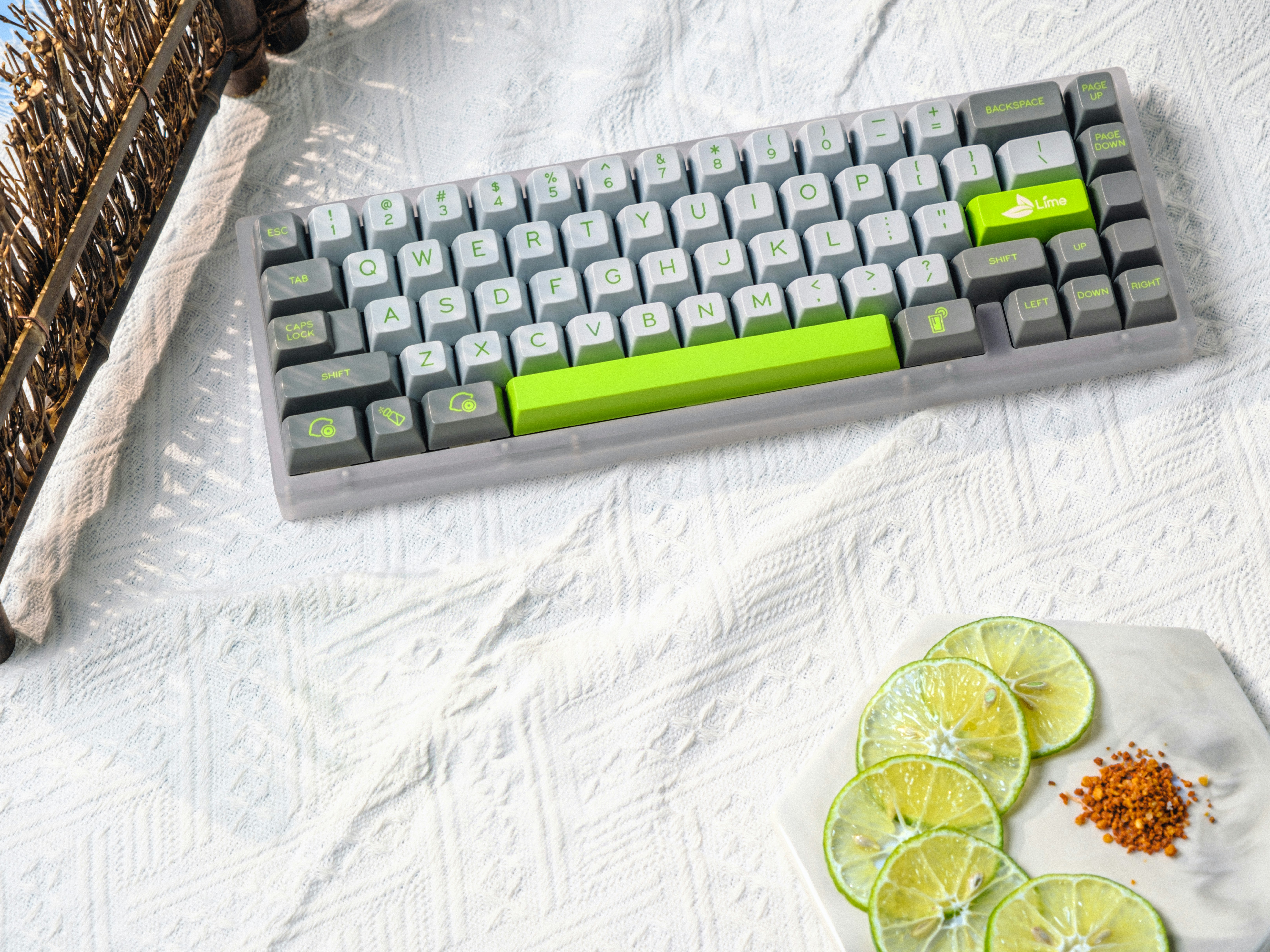 A keyboard and some lime slices on a table