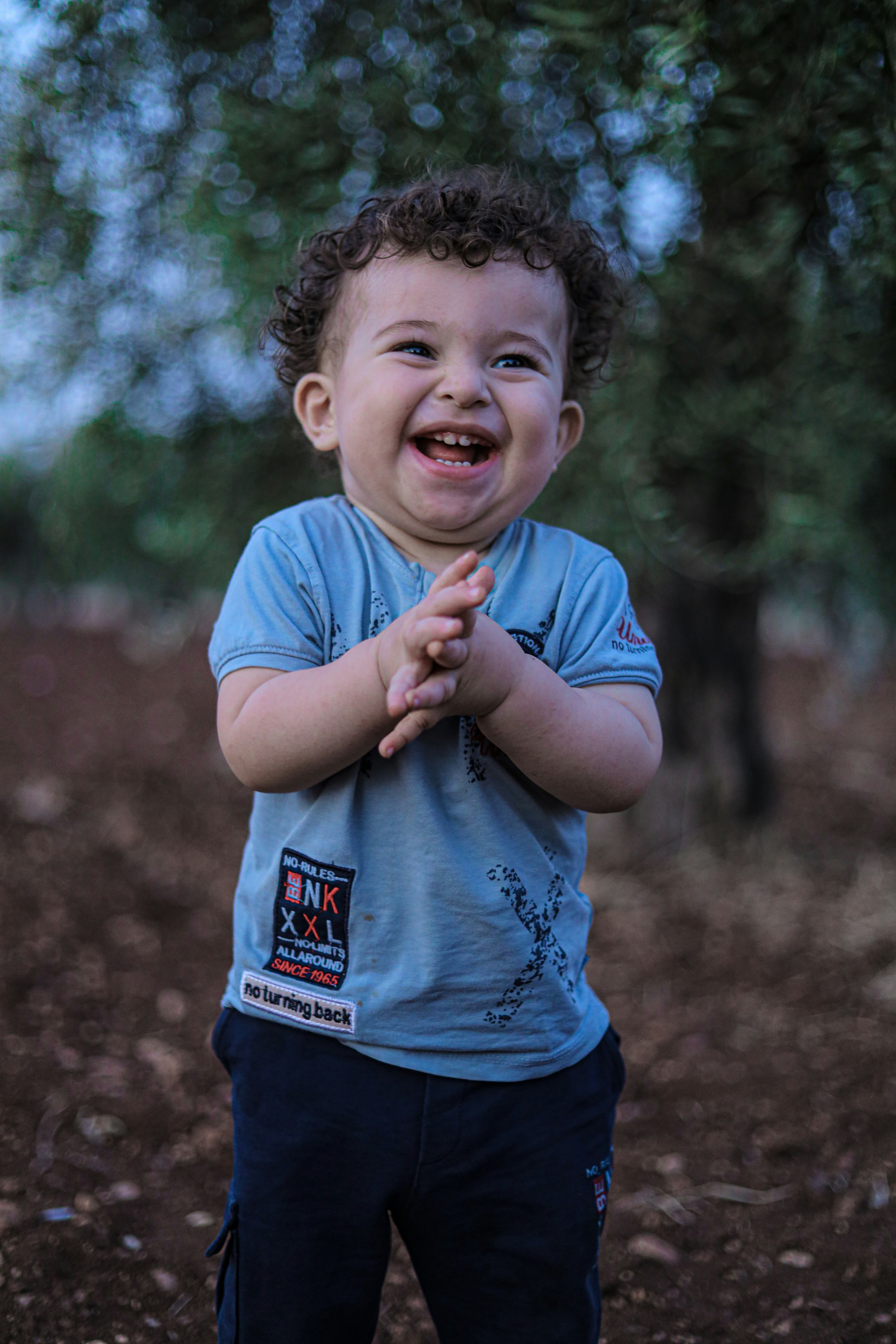 A little boy that is standing in the dirt