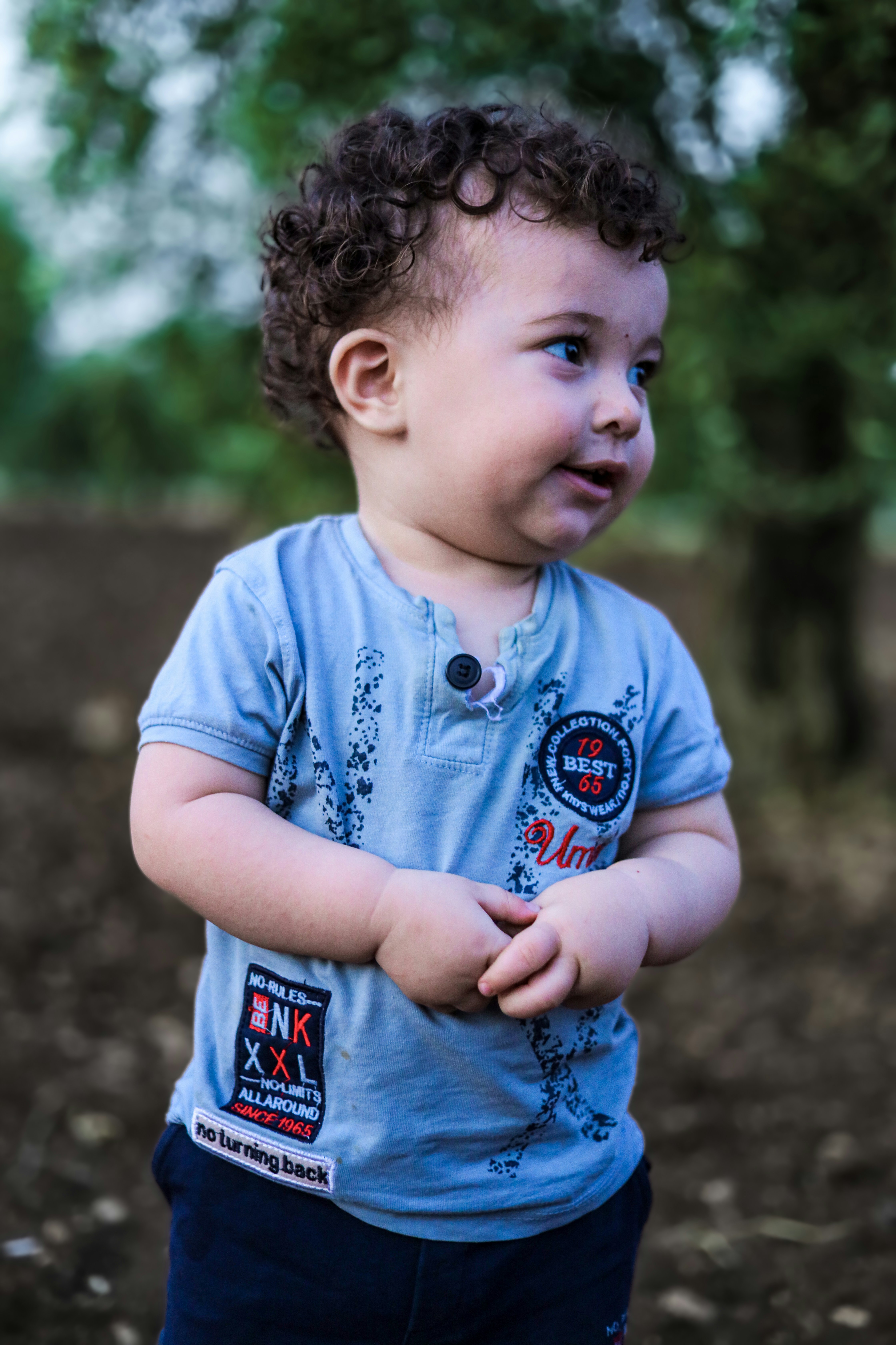 A little boy that is standing in the dirt