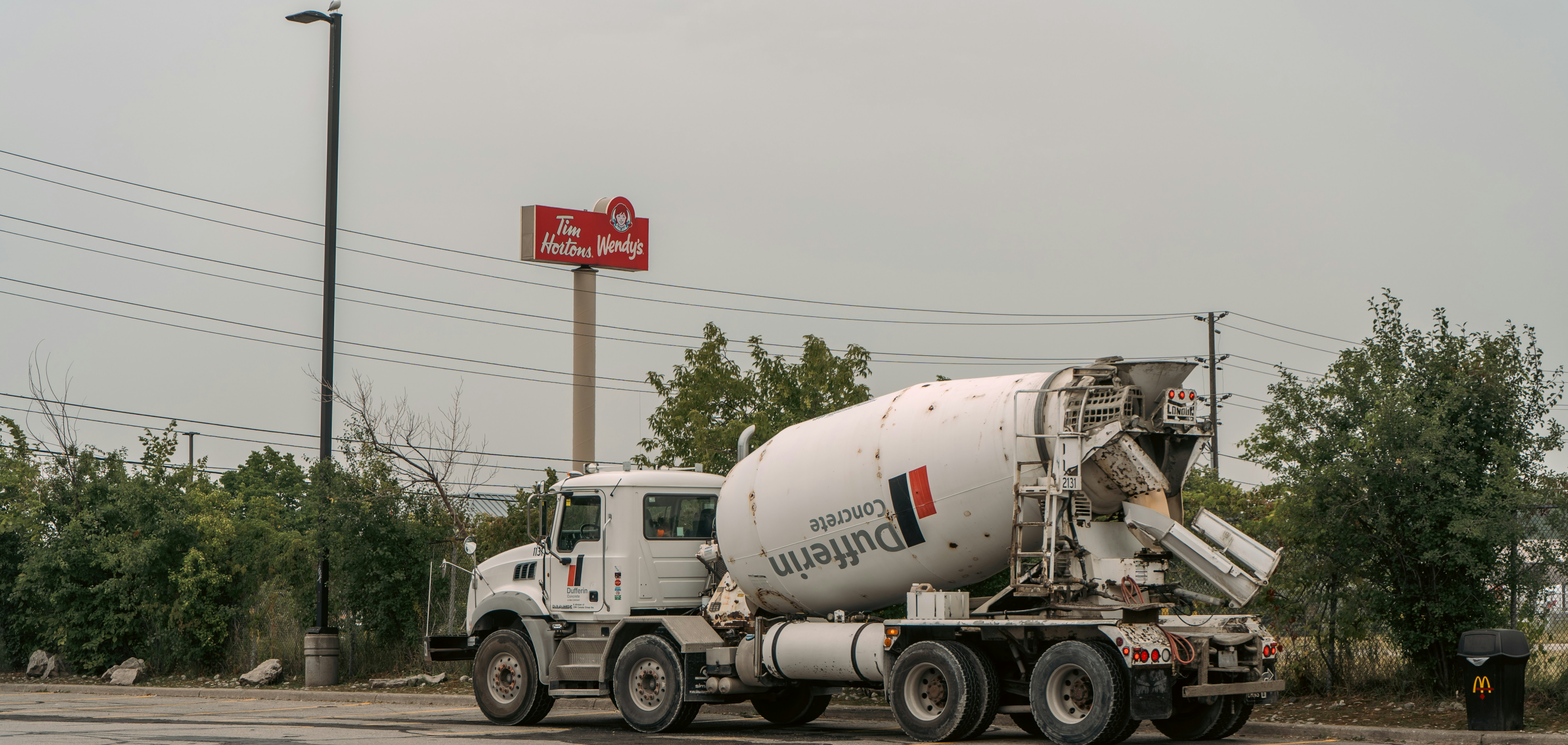 A cement truck parked in a parking lot