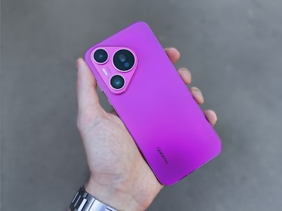 A person holding a purple cell phone in their hand