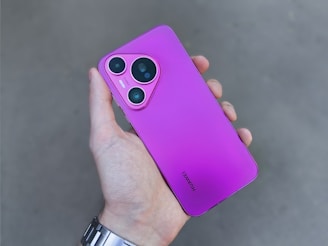 A person holding a purple cell phone in their hand