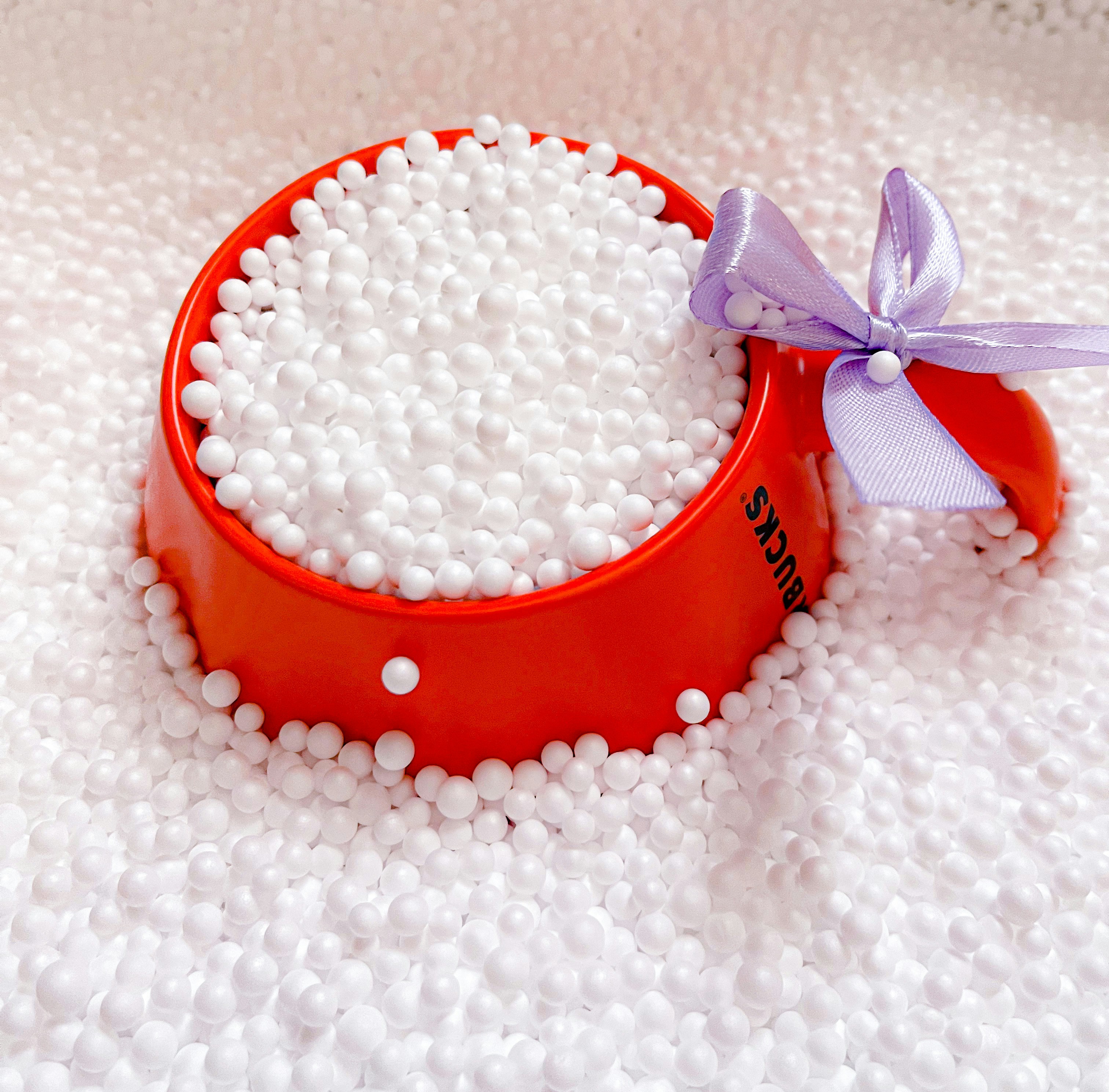 A red and white container with a bow on it