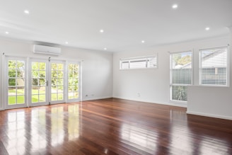 An empty living room with hard wood floors