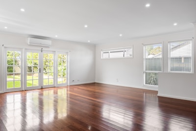 An empty living room with hard wood floors