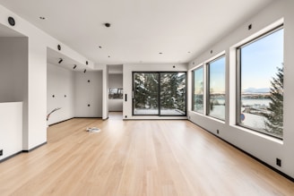 A large empty room with a lot of windows