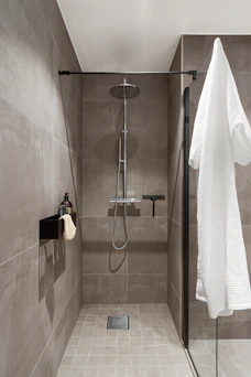 A walk in shower sitting next to a shower head