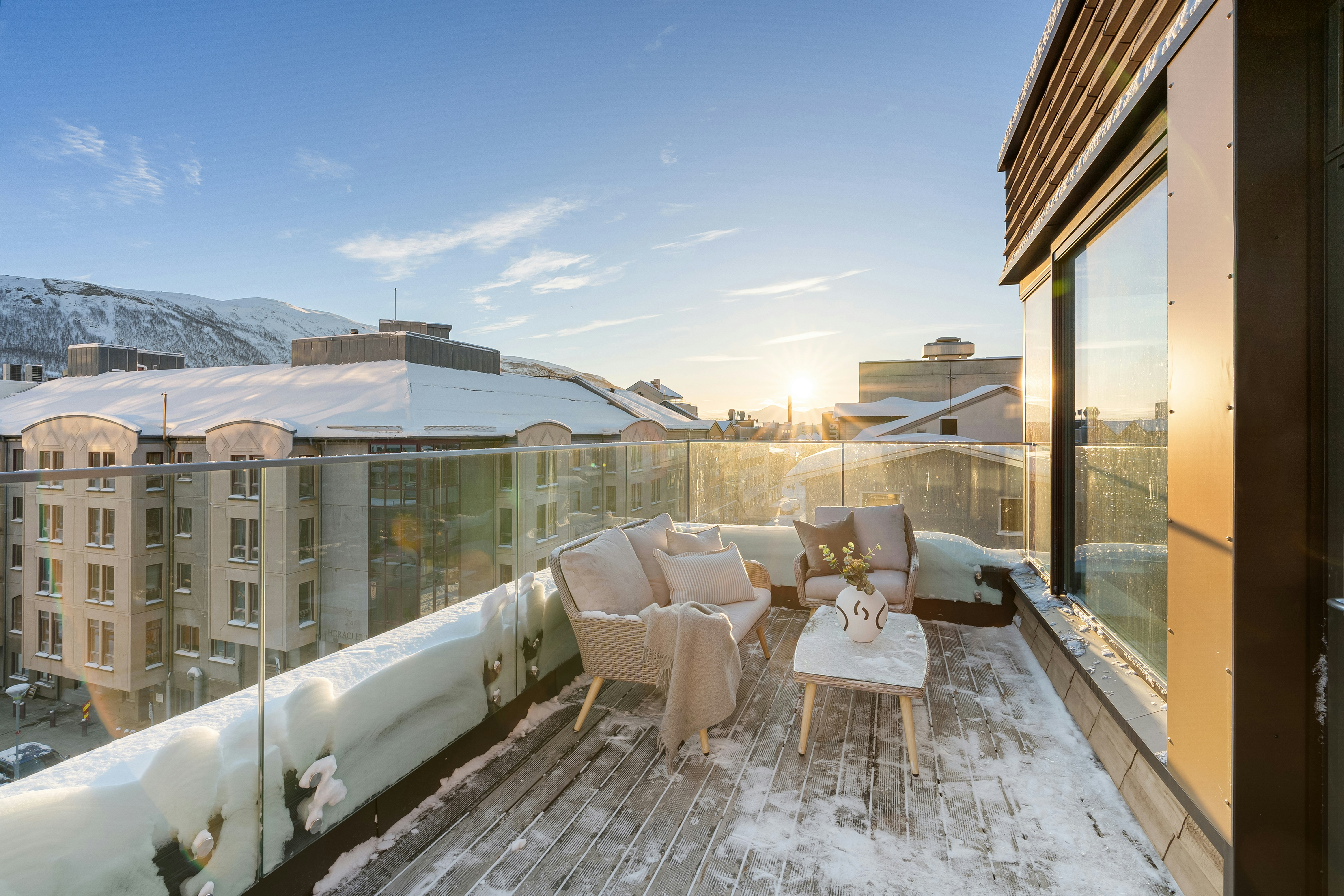 A balcony covered in snow next to a building