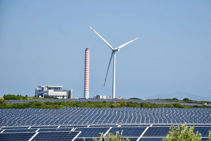 A wind farm with a wind turbine in the background