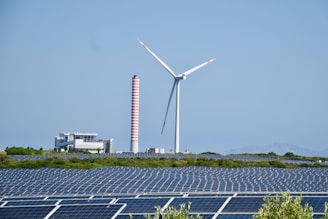 A wind farm with a wind turbine in the background