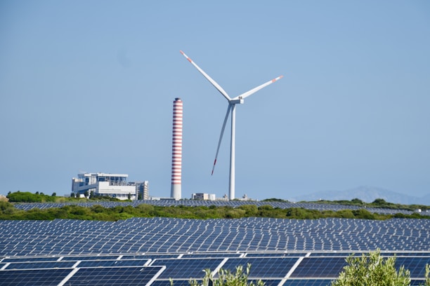 A wind farm with a wind turbine in the background