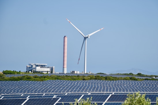 A wind farm with a wind turbine in the background