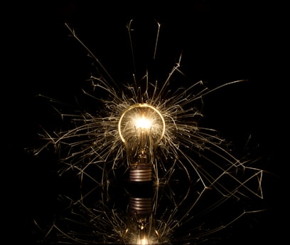 A light bulb that is lit up in the dark