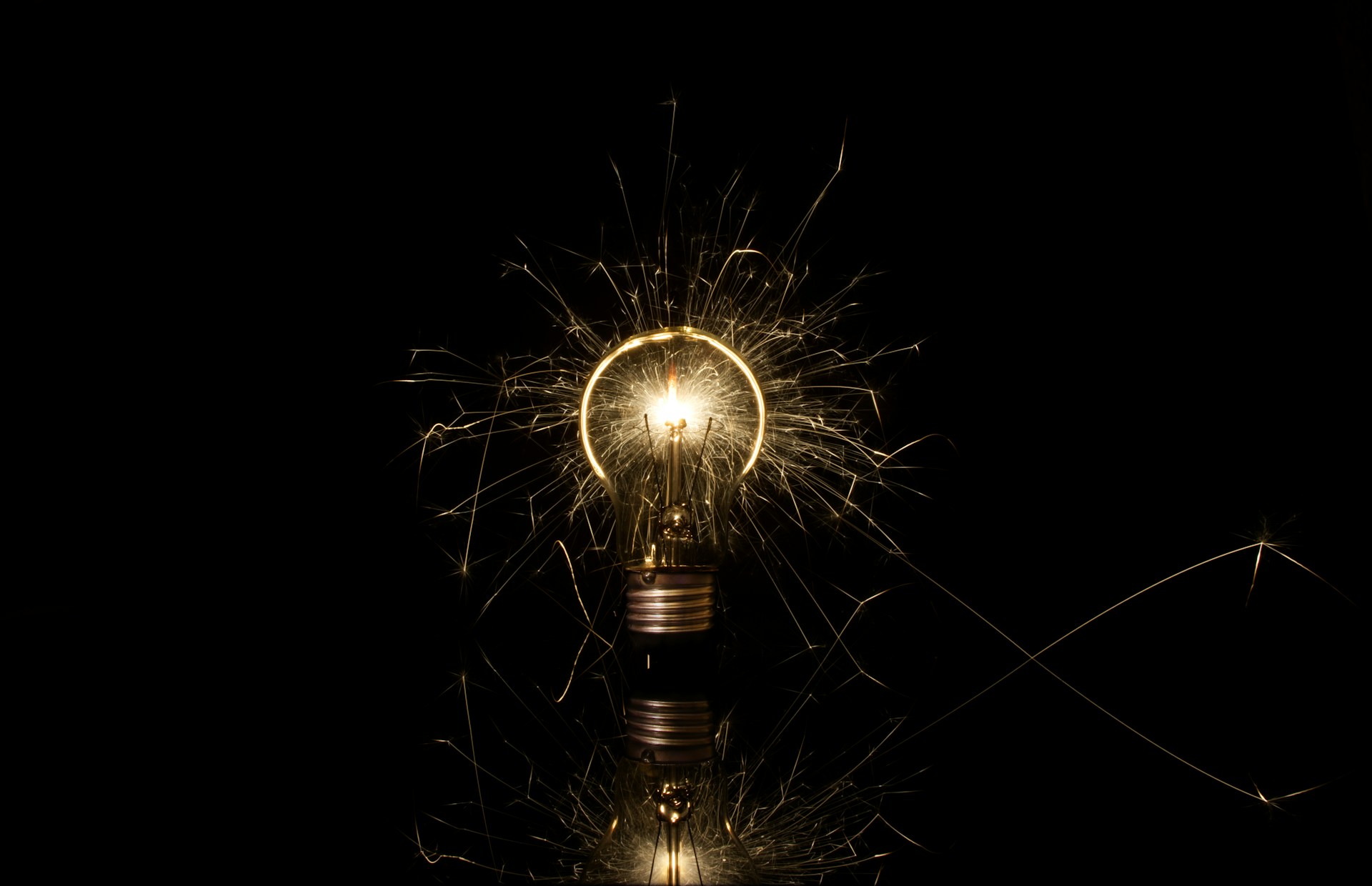 A lit up light bulb sitting on top of a table