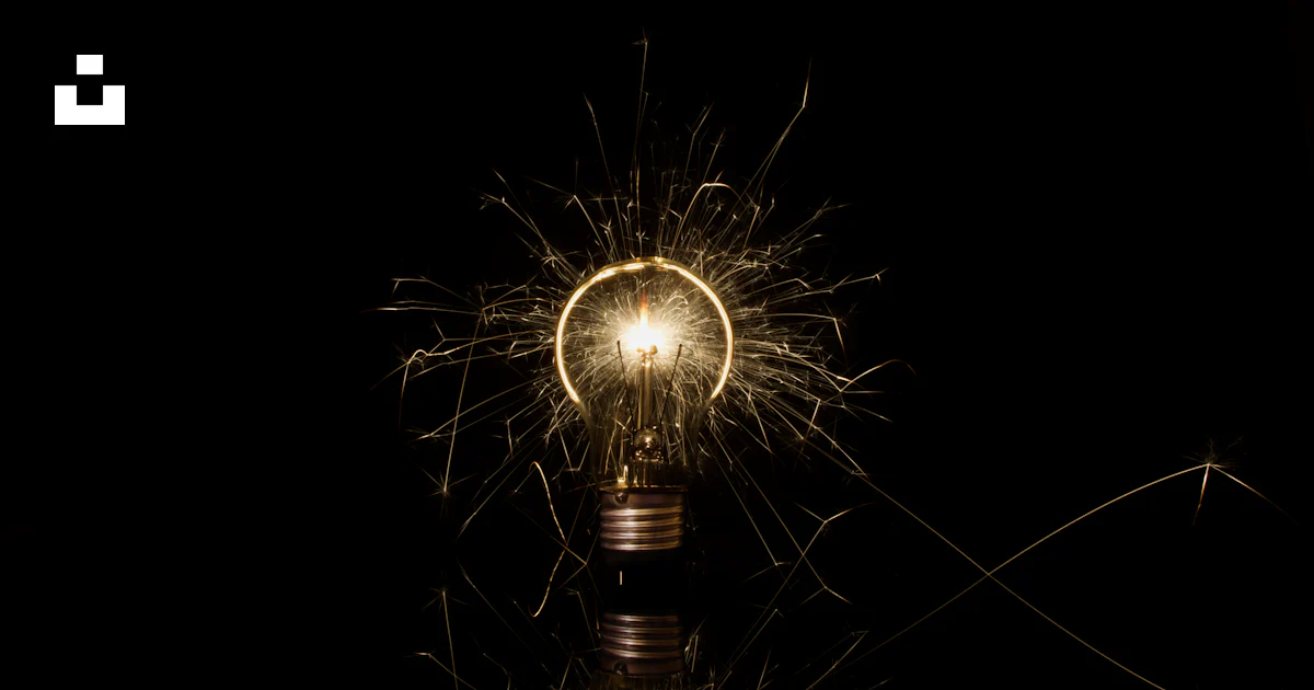 A lit up light bulb sitting on top of a table photo – Free Deutschland ...