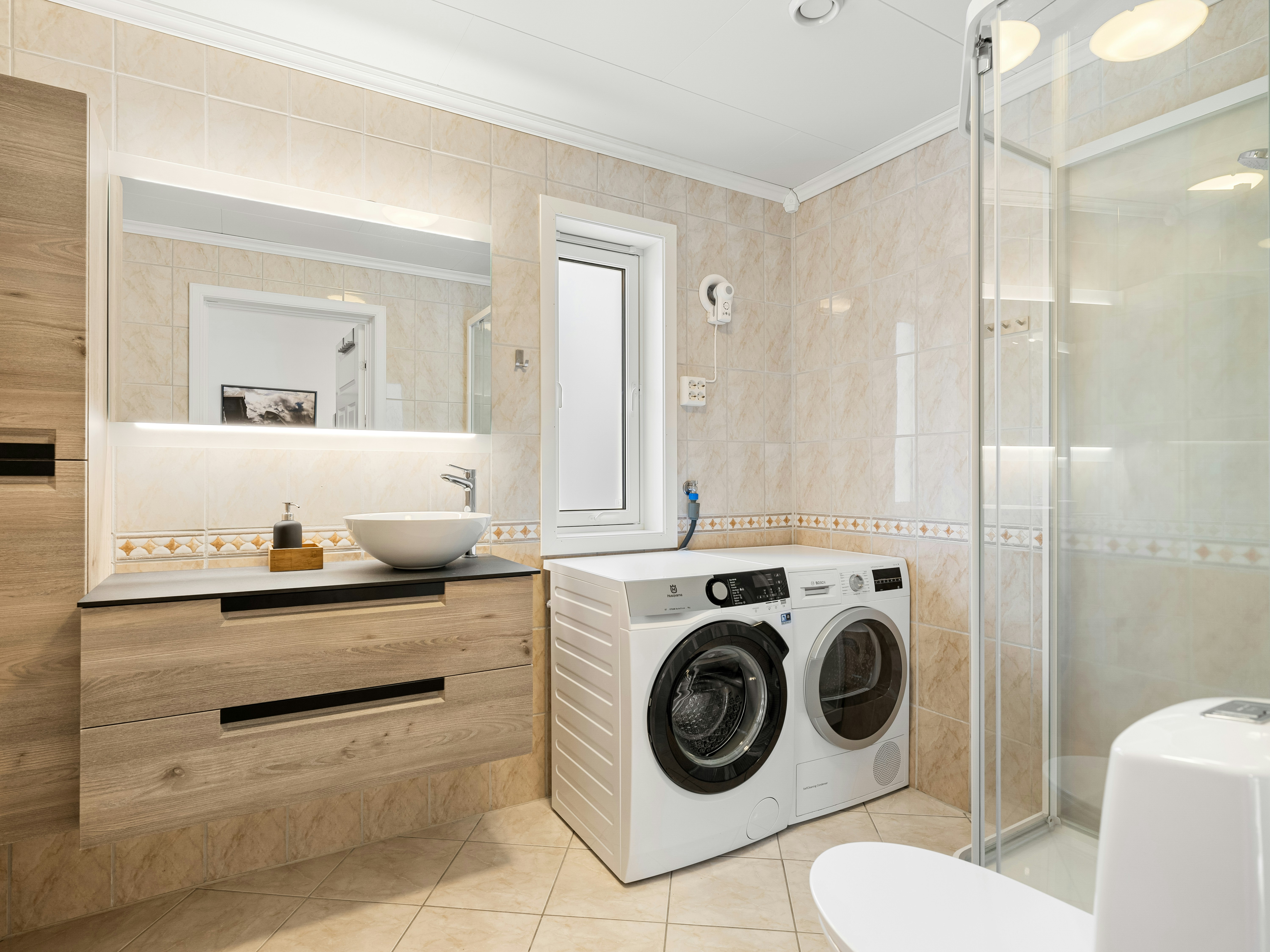 A bathroom with a washer and dryer in it