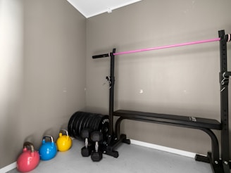 A gym room with a row of exercise equipment