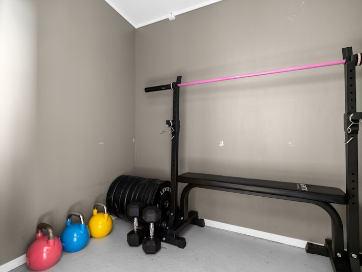 A gym room with a row of exercise equipment