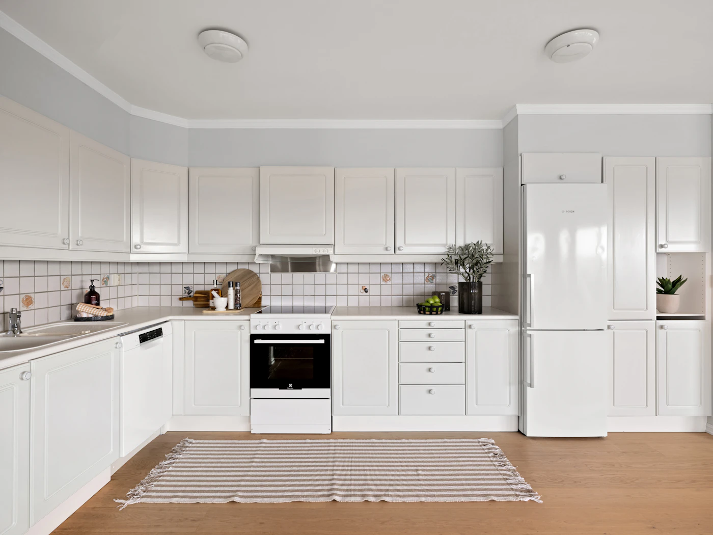 Bright kitchen with painted white cabinets