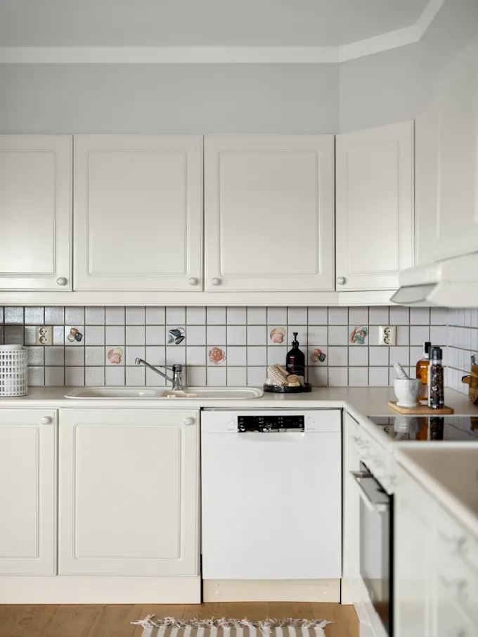 Kitchen with white cabinets and a built-in KitchenAid-style dishwasher serviced by an Altoona appliance repair technician