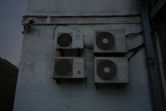 A group of speakers mounted to the side of a building