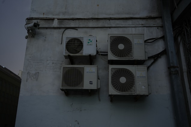 A group of speakers mounted to the side of a building