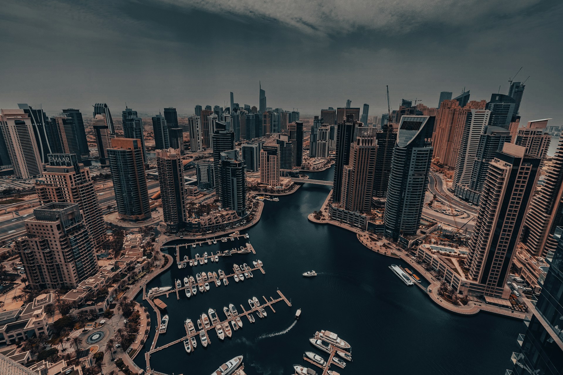 An aerial view of a city with boats in the water