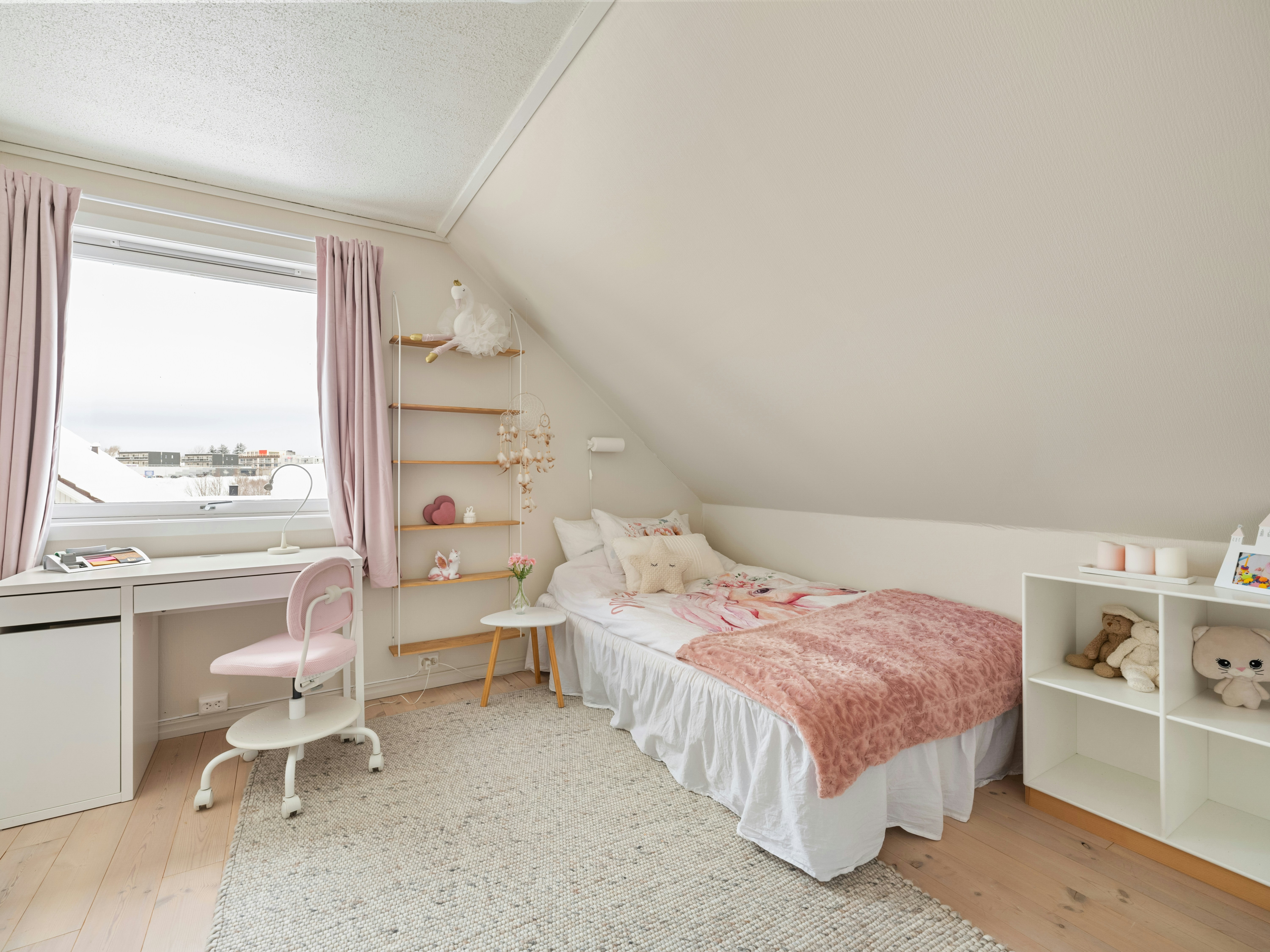 A bedroom with a bed and a desk in it