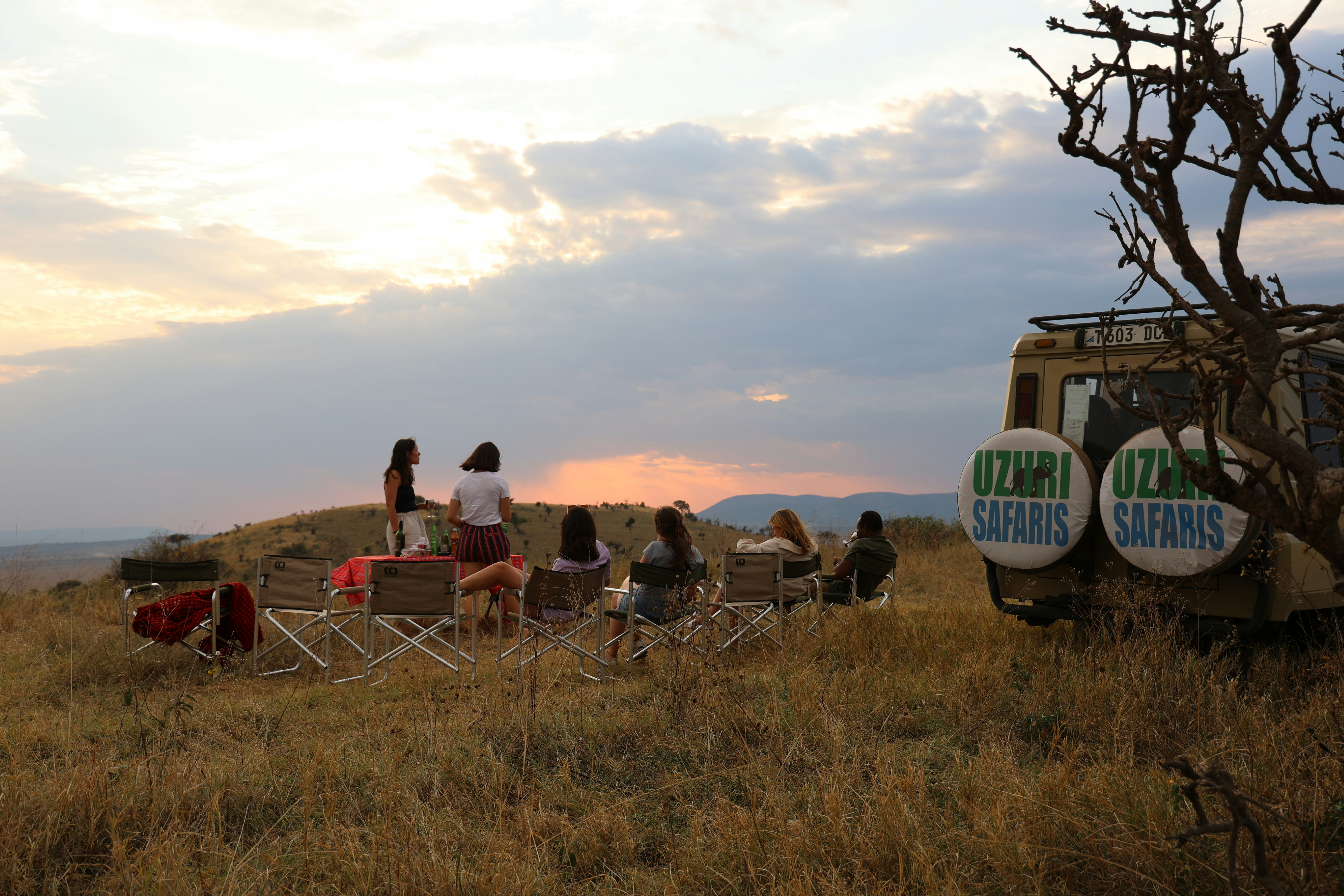 A group of people sitting in chairs in a field