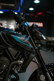 A black and blue motorcycle parked inside of a building