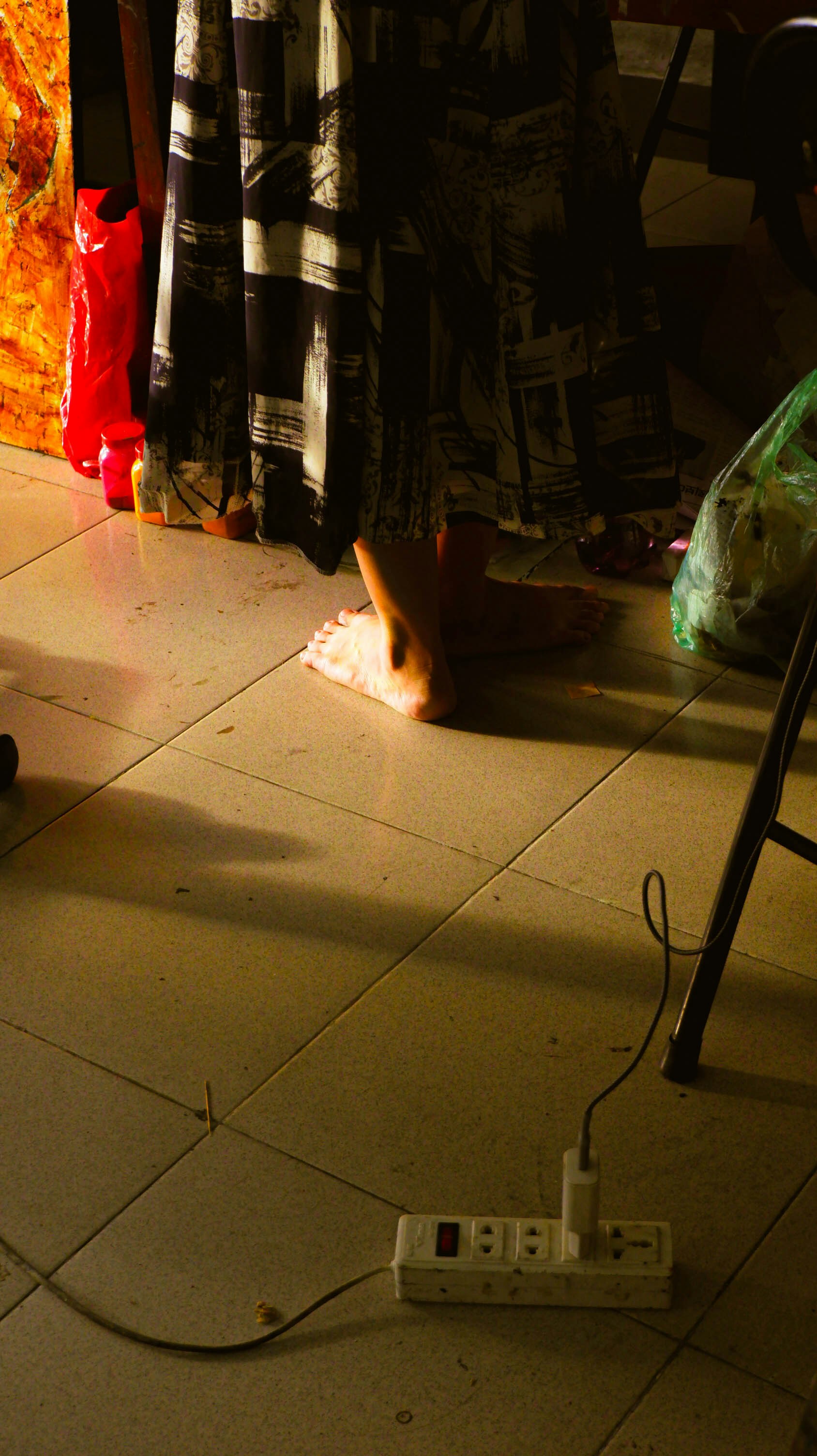 A person sitting on the floor with a remote control