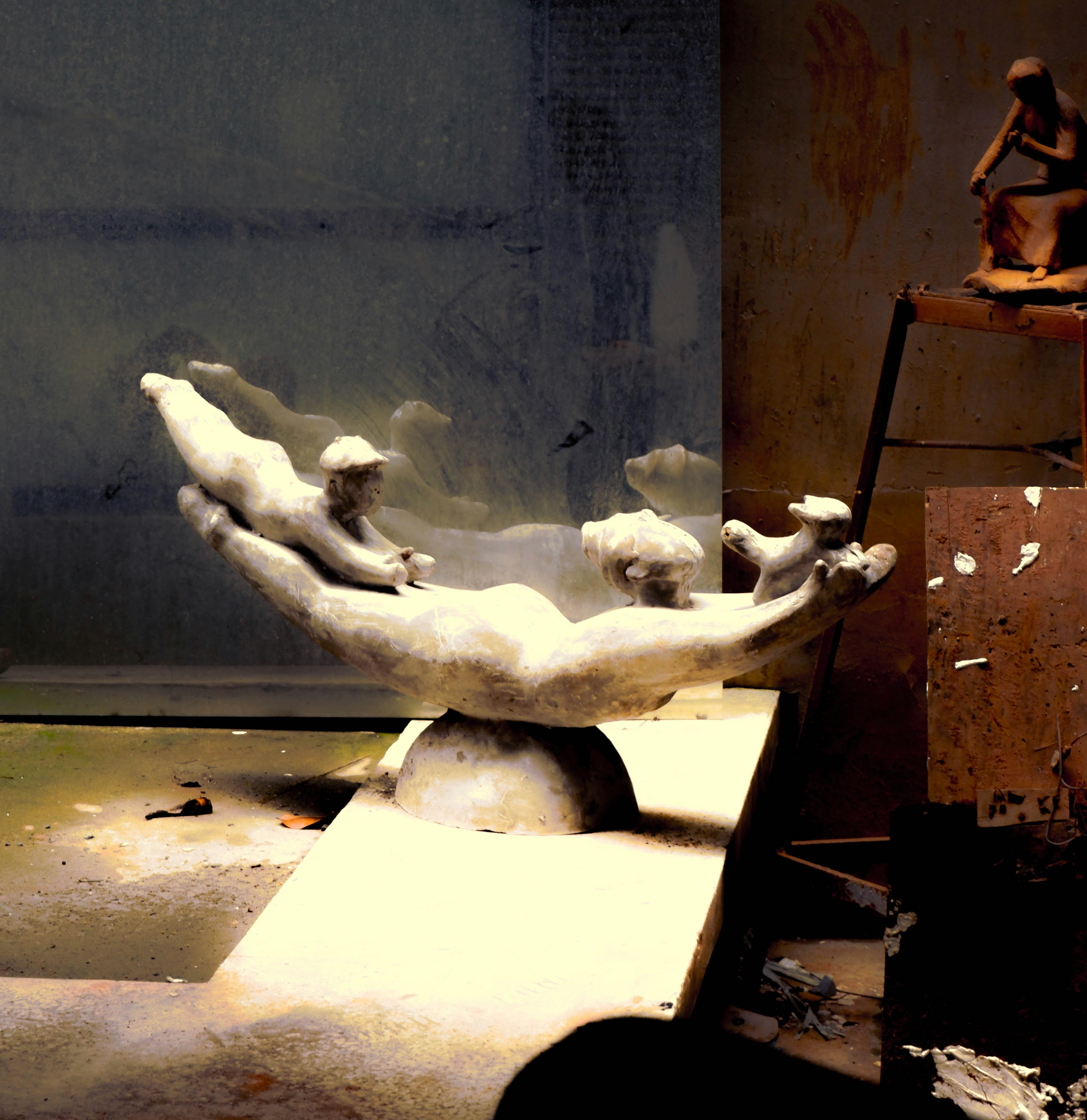 A sculpture of a person on a stepladder