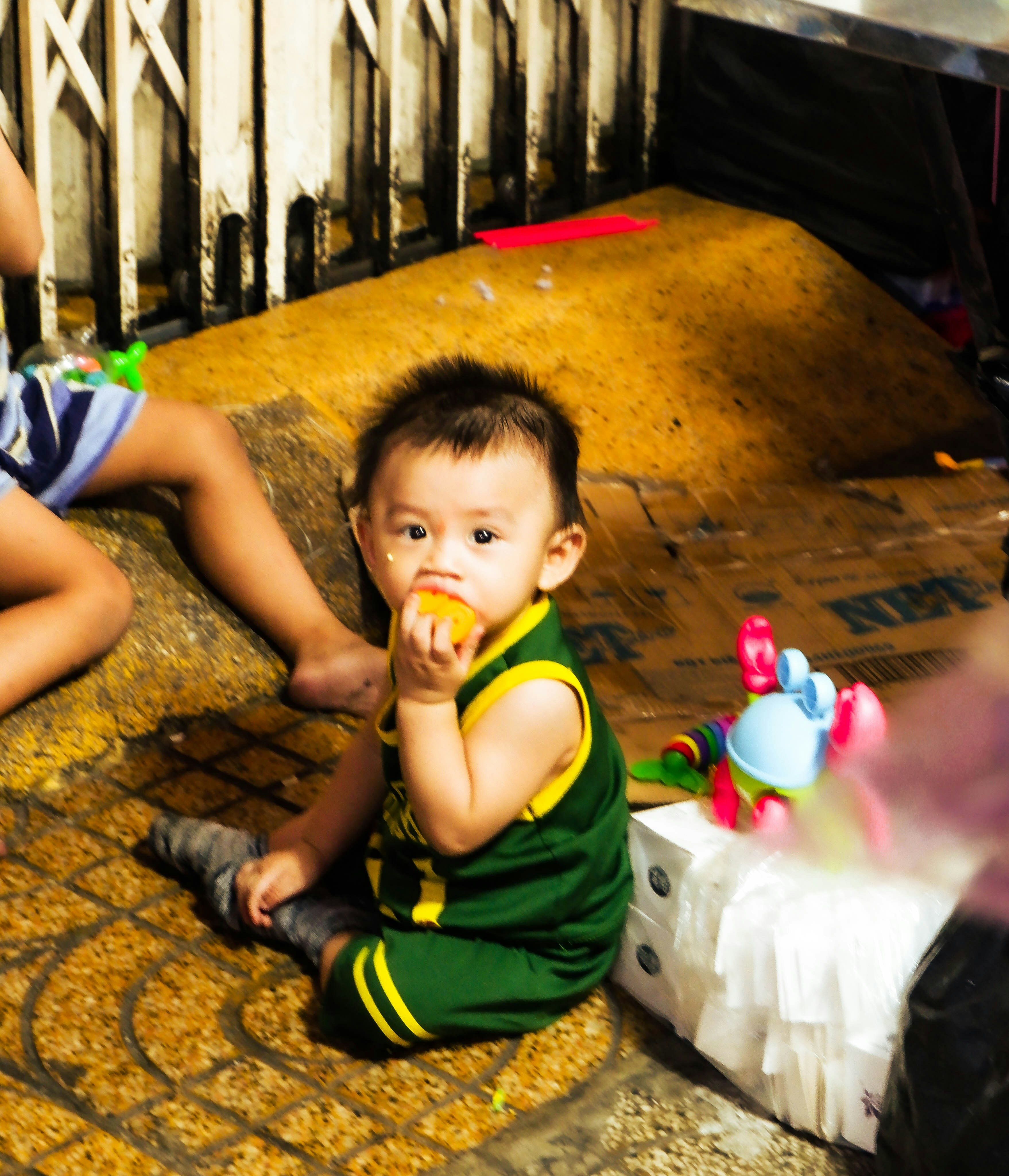 A couple of kids sitting on the ground
