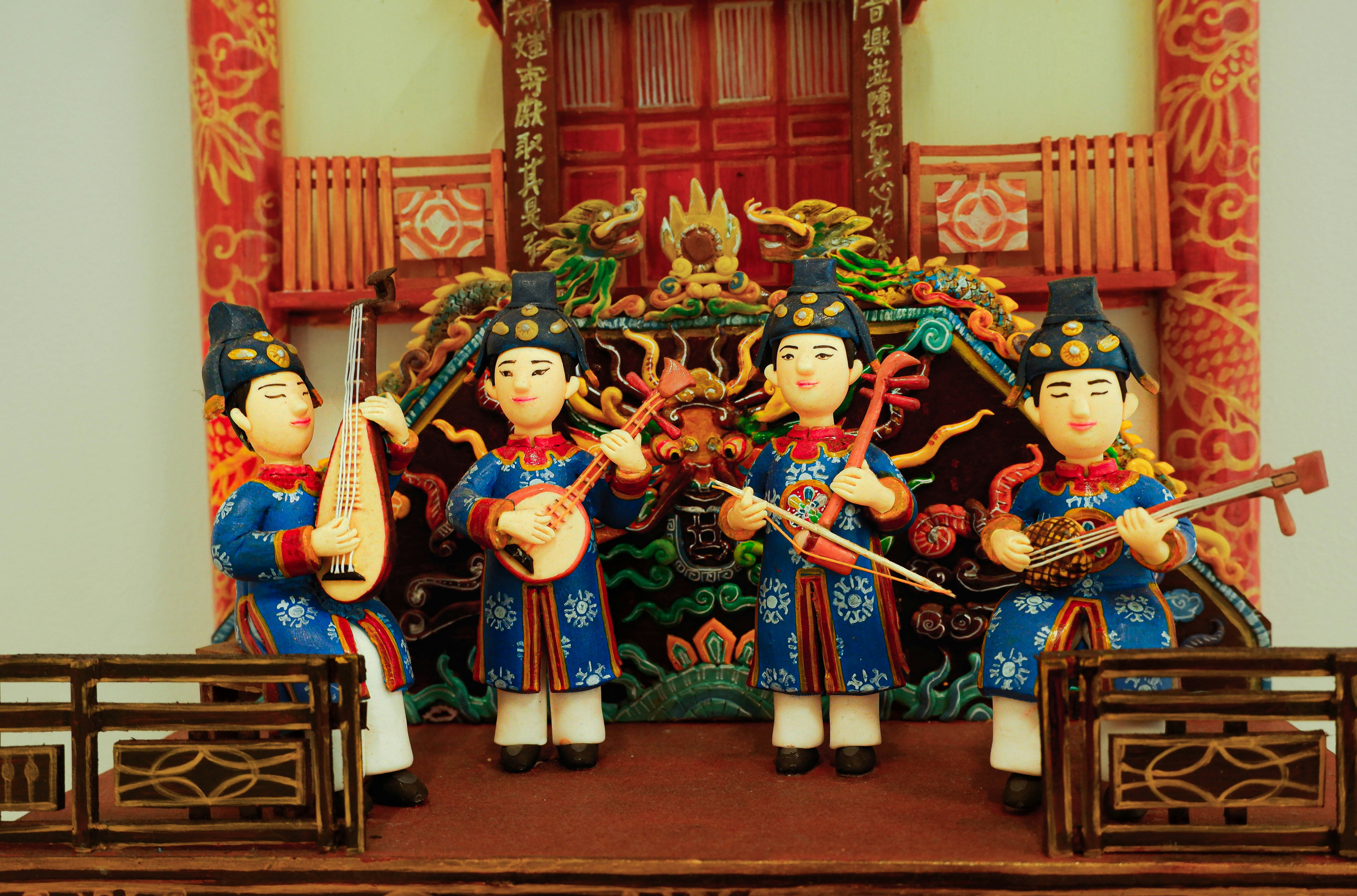 A group of asian figurines on a mantle
