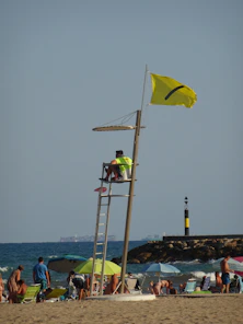 A lifeguard tower on the beach with people on it