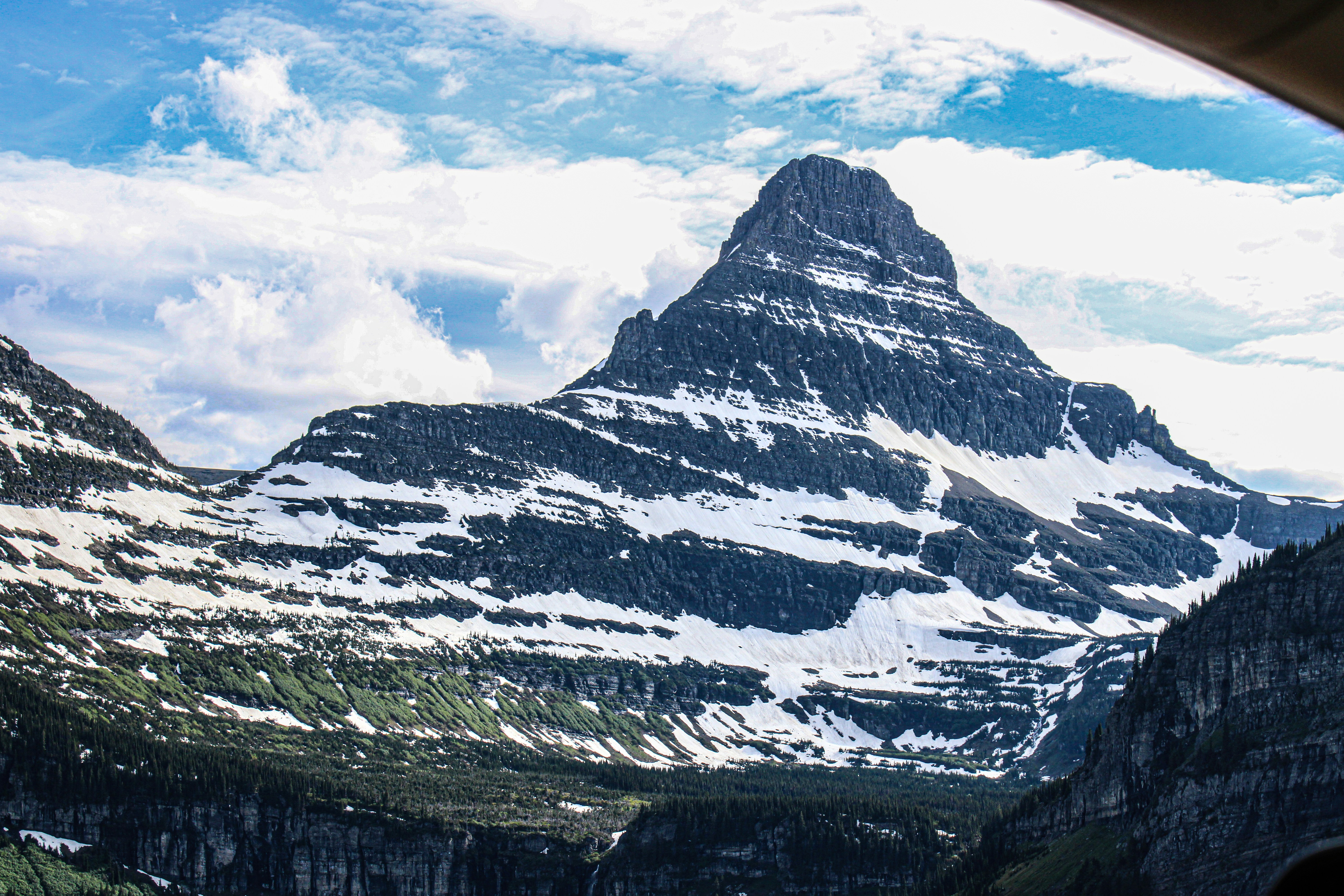 A view of a mountain range from inside a vehicle