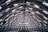 The inside of a building with a roof made of metal beams